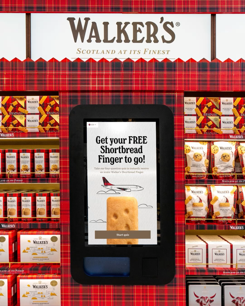 A digital vending machine of Walker's shortbread surrounded by Walker's shortbread box tins and boxes